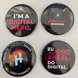 Four black bottom pins with encouraging messages from Herospark Company