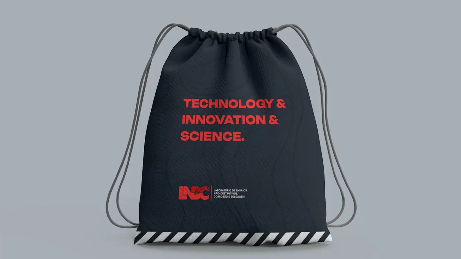 Dark blue sportive bag, with light curved line as texture, and a red text that reads "Technology & Innovation & Science" and LNDC logo
